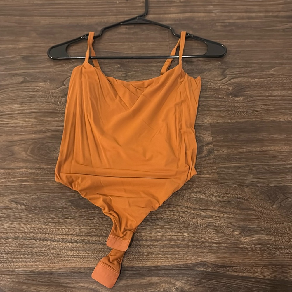 Skims large burnt orange body suit